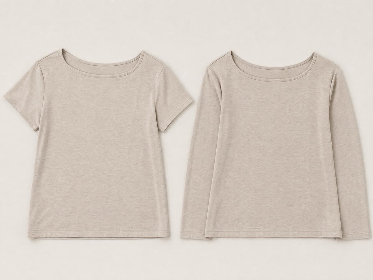 Two matching soft sand jersey tops laid flat side by side, one short-sleeved and one long-sleeved, both with unusually wide relaxed necklines.